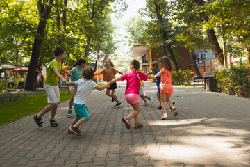 Wall Mural - The happy children are having fun in the park