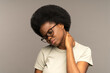 © DimaBerlin - Unhappy black woman massage neck suffering from backache or muscle spasm. Unhealthy african american millennial female touching painful neck rubbing body to relieve strain or pain. Healthcare concept