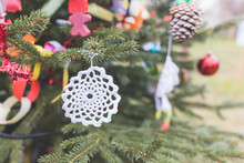 DIY White Doily On Christmas Tree. Handmade Christmas Decoration Ideas For Children. Environment, Reuse, Recycle, Upcycling And Zero Waste Concept. Selective Focus, Copy Space