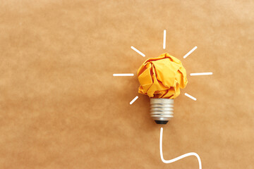 Wall Mural - Concept image of crumpled paper lightbulb, symbol of scr, innovation and eco friendly business