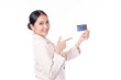 © ueaphan - Portrait of a happy young asian woman wearing suit holding bank card, credit card isolated on white background. Business online shopping concept.
