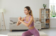 © Studio Romantic - Happy, beautiful, sporty, fit, slim young Caucasian woman in modern activewear doing forward lunges exercise during her routine fitness workout at home