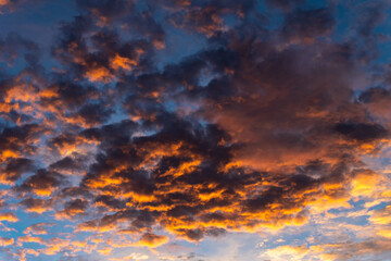 Wall Mural - the sky at dusk The rays of the sun hit the clouds, creating beautiful and frightening colors at the same time..