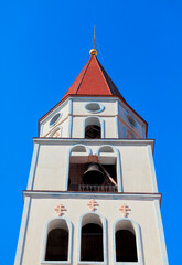 Wall Mural - Bell tower with iron bell . Steeple with red dome  