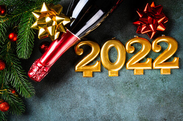 2022 number with champagne bottle and decor. Happy new year and festive concept. Top horizontal view, copyspace. New Year Flatly. Christmas flatlay. New year 2022. New year concept.