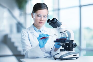 Wall Mural - Microbiologist doctor analyzing vaccine results using medical microscope researching