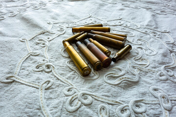 Empty cartridges of various calibers, after shooting, on the work table