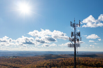 Aerial view of mobile phone cell tower over forested rural area of West Virginia to illustrate lack of broadband internet service