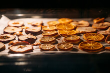 How To Dry Orange Slices For Christmas Decorating. Oranges Drying In Oven On Metal Rack And Baking Paper. Selective Focus