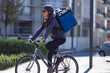 © aerogondo - delivery woman riding electric bicycle in city