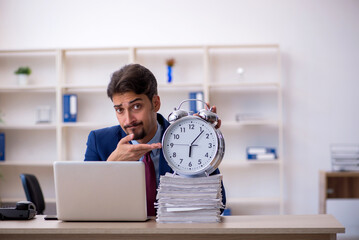 Wall Mural - Young businessman employee and too much work in the office