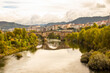 Old roman bridge in Ourense City , with amazing autumn colors. amazing autumn landscape with Rio Mino in foreground. 