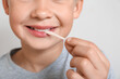 © Pixel-Shot - Little boy chewing gum on light background, closeup