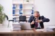 © Elnur - Old male employee and too much work in the office