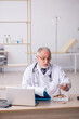 © Elnur - Old male doctor working in the clinic