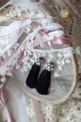 Poster - Stylish beautiful tassel earrings on lace. Fashionable accessory for the holiday.