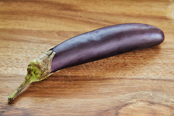 Wall Mural - Japanese eggplant lies on wooden board in the kitchen