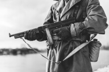 Soldier Of USA Infantry Of World War II Holds Submachine Weapon In Hands. Black And White Photography