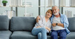 © Bangkok Click Studio - Caucasian old senior romantic aged lover couple in casual wear gray bearded and hair grandpa husband and lovely grandma wife sitting smiling cuddling hugging together on sofa