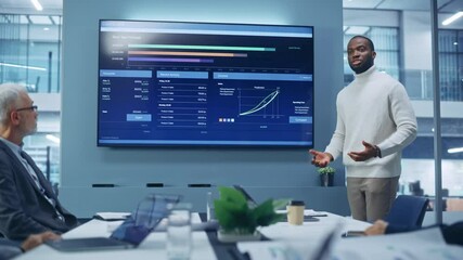 Wall Mural - Diverse Modern Office: Motivated Black Businessman Leads Business Meeting with Managers, Talks, uses Presentation TV with Statistics, Charts, Big Data. Digital Entrepreneurs Work on e-Commerce Project