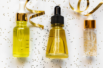 Set of beauty face oils with vitamin C, 24k gold and essential herb extrcts. Christmas and new year cosmetic gifts concept