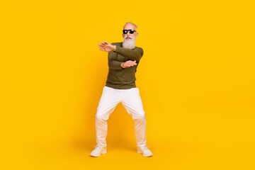 Wall Mural - Photo of crazy funky old man enjoy retro disco dance wear green shirt pants shoes isolated yellow color background