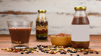 Supplementary drink glass and juice bottle of tasty mixed ingredients of organic cereal and fresh natural beans as vitamin therapy and protein nourishment for health refreshment