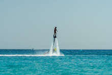 Man Flyboarding Above The Azure Sea. Water Adventure