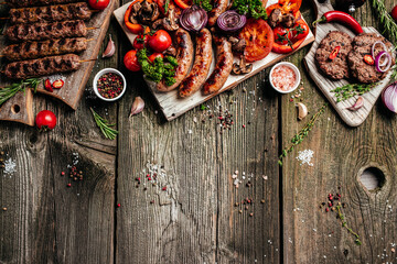 grilled meat and vegetables on wooden table. barbecue menu. banner, menu, recipe place for text, top