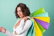 © Анастасия Каргаполов - Young woman in a white evening dress on a light green background with bright pink makeup holds shopping bags