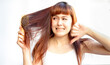 © Patcharanan - Woman with messy hair on white background. Asian woman in panic one hand and showing thumbs down because hair loss. Hair with a comb in hand female having serious fall damaged hair caused by pollution
