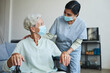 © Seventyfour - Portrait of female nurse assisting senior woman in wheelchair at home or in retirement center, both wearing masks