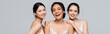 © LIGHTFIELD STUDIOS - Cheerful multicultural women looking at camera isolated on grey, banner