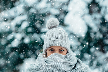 Beautiful young woman wearing scarf and a a hat on a cold winter day