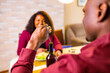 © yurakrasil - african american couple eating italian food pasta in living room in stylish marsala color jacket