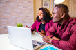 © yurakrasil - african american woman and man in home office in living room start up