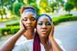 african american couple of two young beautyful women in summer park