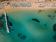 © Anton Tolmachov - Aerial view of sun loungers on beach with clear sea