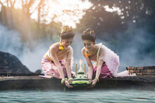 Loy Krathong Tradition , Beautiful Women Dressed In Thai National Costumes. Put The Krathong On The River, The Word Krathong Refers To Basket And Loy Means To Float