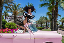 Bikini Fashion. Beautiful Sexy Blonde Woman In Colorful Swimsuit Near The Pink Car On Cuba Havana. Spring And Summer Fashion Model Concept. Vintage And Retro Style.