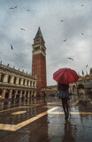 Fototapeta Miasto - Girl possing with an umbrella in Venezia on a rainy day
