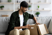 Handsome Young Indian Man Opening Box A Home