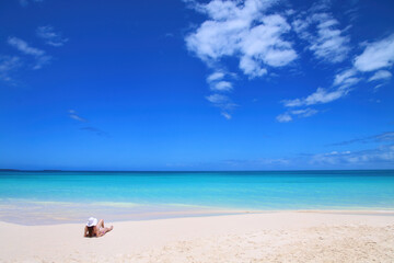 Wall Mural - Woman relaxing on Fayaoue beach on the coast of Ouvea lagoon, Mouli and Ouvea Islands, New Caledonia