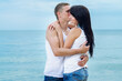 © omelnickiy - guy and a girl in jeans and white t-shirts on the beach