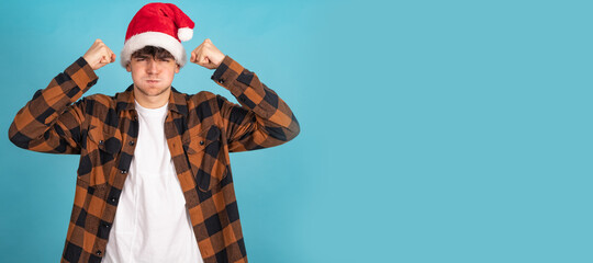 Wall Mural - isolated young man with santa claus christmas hat