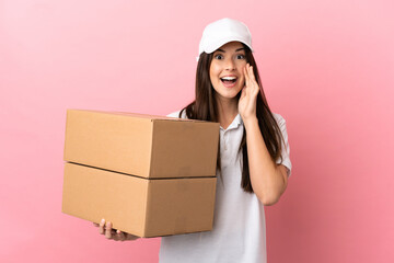 Delivery girl over isolated pink wall with surprise and shocked facial expression
