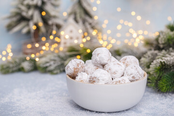 Traditional Christmas snowball cookies with almonds on snowy  background