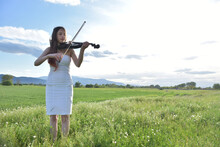A Girl In A White Dress With A Black Violin,