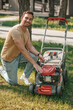 © zinkevych - Smiling man turning on lawn mower