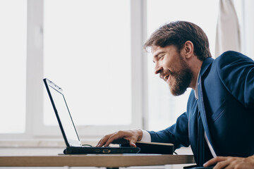 Man working for a laptop in the office emotions internet professional